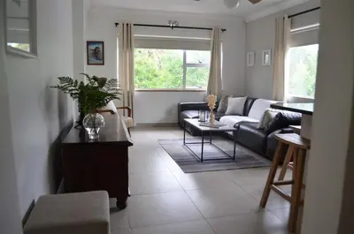a living room with a couch and a table at Stellenhof Inn - walking distance to town center in Stellenbosch