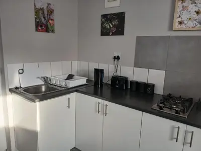 a kitchen with a sink and a counter top at Cozy, self-catering Garden Flat in Cape Town