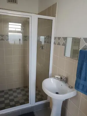 a bathroom with a sink and a shower at Cozy, self-catering Garden Flat in Cape Town