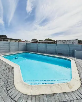 a large blue swimming pool on top of a building at Cedar Apartments on Century City in Cape Town
