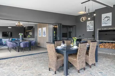 a dining room with a table and chairs at Red River Valley in Rooiels