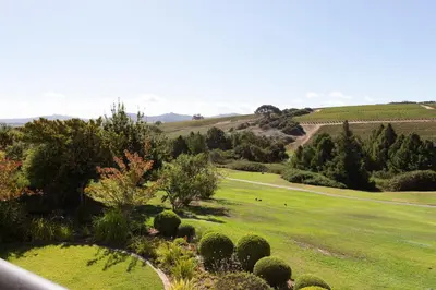 a view of a green field with trees and bushes at Winelands Golf Lodges 8 in Stellenbosch
