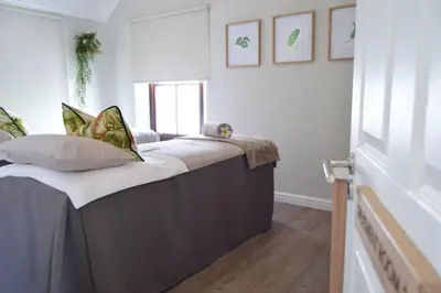 a bed with pillows on it in a room at Winelands Golf Lodges 17 in Stellenbosch