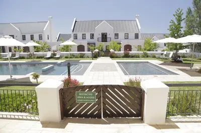 a gate in front of a building with a pool at Winelands Golf Lodges 17 in Stellenbosch