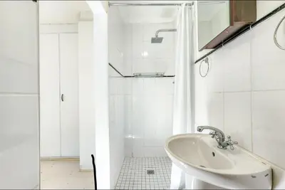 a white bathroom with a sink and a shower at One Bedroom Loevenstein in Tygerberg Hills