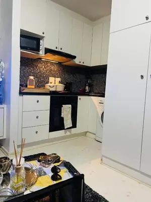 a kitchen with white cabinets and a counter top at One Bedroom Loevenstein in Tygerberg Hills