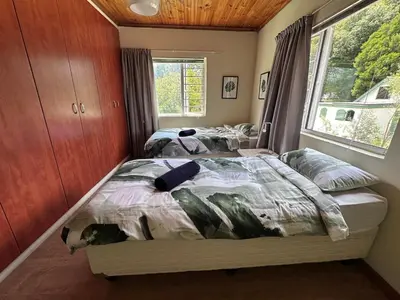 a bedroom with two beds and a window at Nature Lover's Home in Grabouw in Grabouw