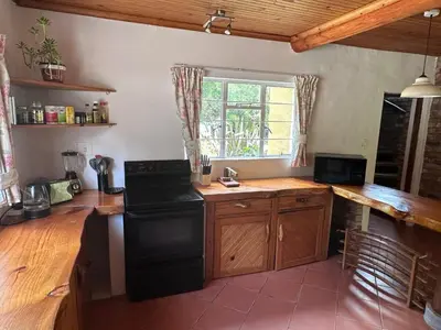 a kitchen with a stove and a counter top at Nature Lover's Home in Grabouw in Grabouw