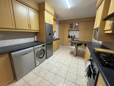 a kitchen with a washer and dryer in it at Serene waterfront escape! Luxury, King bed! in Durbanville