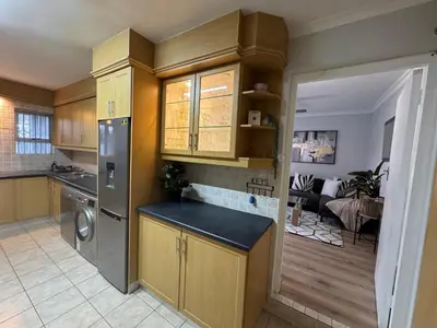 a kitchen with a sink and a refrigerator at Serene waterfront escape! Luxury, King bed! in Durbanville