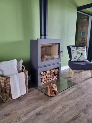 a living room with a fireplace and a chair at Scenic Mountain & Winelands views, Modern Design in Tygerberg Hills