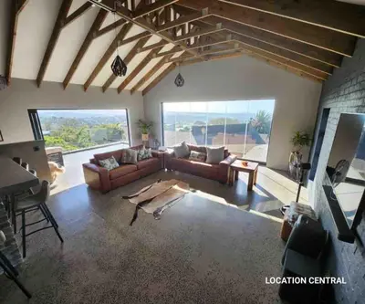 a living room with a couch and a table at Scenic Mountain & Winelands views, Modern Design in Tygerberg Hills