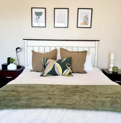 a bedroom with a large white bed with pillows at Scenic Mountain & Winelands views, Modern Design in Tygerberg Hills