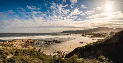a view of a beach with the ocean and rocks at Hermanus Waterfront Boho Studio Apartment, Whale Coast Hideaway in Hermanus