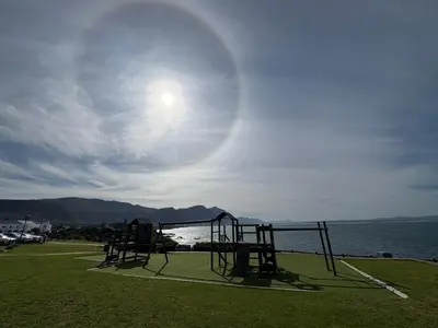 an empty playground with a view of the water at Hermanus Waterfront Boho Studio Apartment, Whale Coast Hideaway in Hermanus