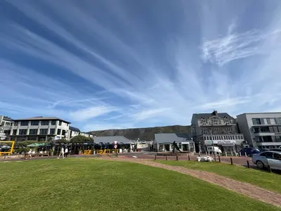 a view of a city with buildings and a grass field at Hermanus Waterfront Boho Studio Apartment, Whale Coast Hideaway in Hermanus