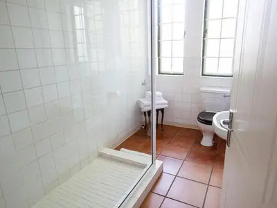 a bathroom with a shower with a toilet and a sink at The Habit Apartments in Worcester