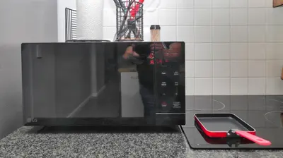 a person taking a picture of a microwave oven at Happy Days in Paarl