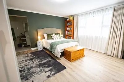 a bedroom with a bed and a large window at 44 on Mountain Drive in Hermanus