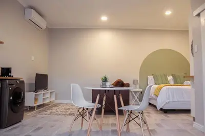 a bedroom with a bed and a table and chairs at Sage And Vine Studio in Worcester