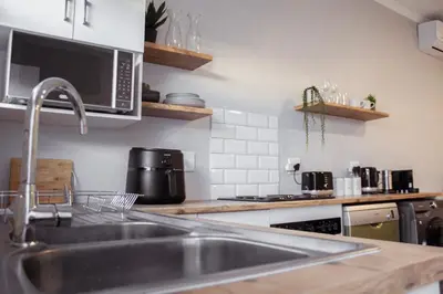a kitchen with a sink and a microwave at Sage And Vine Studio in Worcester