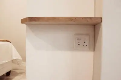 a wall with a lightswitch on a white wall at Sage And Vine Studio in Worcester