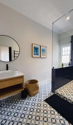 a bathroom with a tub and a sink and a mirror at Stunning Home in Hermanus Town Centre in Hermanus