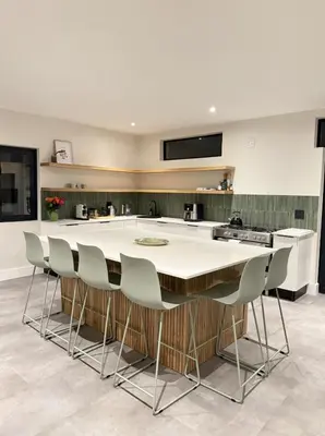 a kitchen with a large white island with chairs at Stunning Home in Hermanus Town Centre in Hermanus