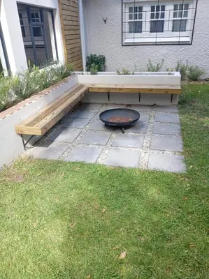 a fire pit and a bench in a yard at Stunning Home in Hermanus Town Centre in Hermanus
