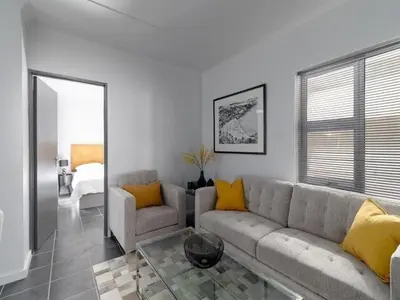 a living room with a couch and a table at 4 Essex Street Apartment in Cape Town