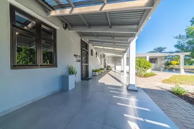an outdoor patio with awning on a house at LEO Sky Guest House in Simondium
