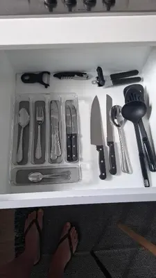 a drawer full of kitchen utensils on a table at Blouberg Luxury Studio Apartment in Cape Town