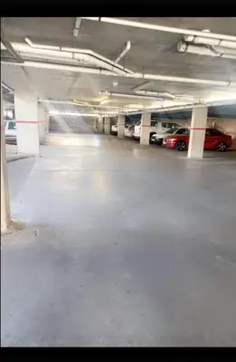 an empty parking garage with cars parked in it at Elegant 2 bedroom apartment with Mountain Views in Cape Town