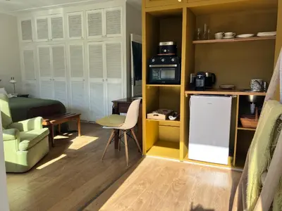 a small room with a kitchen and a living room at Wholeness Accommodation in Hermanus