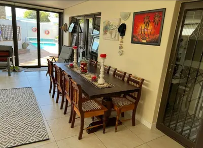 a dining room with a table and chairs at Strand cosy 2 bedroom house in Strand