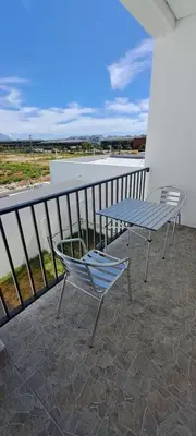 two chairs and a table on a balcony at Glorious44 in Cape Town