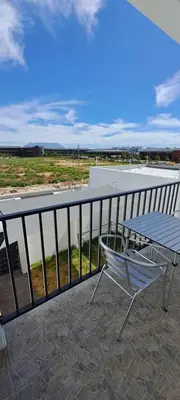 a chair and a table on a balcony at Glorious44 in Cape Town