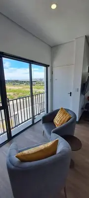 a living room with two couches and a large window at Glorious44 in Cape Town