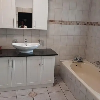 a bathroom with a sink and a bath tub at Tripple S in Bellville