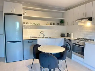 a kitchen with a table and chairs in it at 18 On 40 North in Cape Town