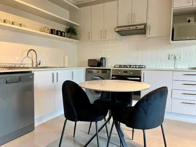 a kitchen with a table and chairs in it at 18 On 40 North in Cape Town