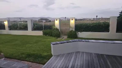 a backyard with a bench and a fence at Cape Golf Villa in Cape Town
