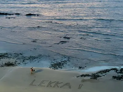 a person sitting on the beach next to the ocean at Strand Overnight - 24 Hour check-in - close to major private hospitals - sleeps 1- 4 guests - self catering - quiet neighborhood - week night low rate for single guest - weekends min 2 nights in Strand