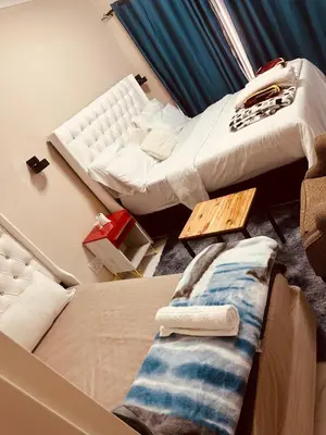 a room with two beds and a couch at Forest Home Accommodation in De Grendel