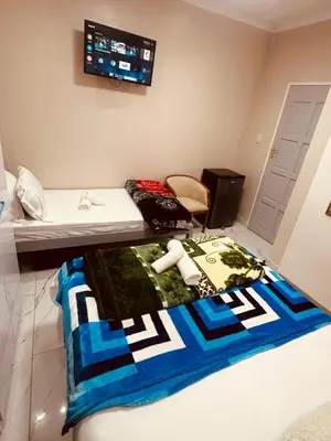 a room with a table with a blanket on it at Forest Home Accommodation in De Grendel