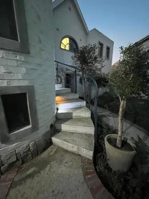 a stone house with stairs leading to a building at Rocket Room in Stellenbosch