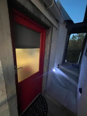 a red door on a house with a window at Rocket Room in Stellenbosch