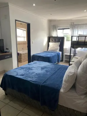 a hotel room with two beds and a window at Ludiz guest house in Parow
