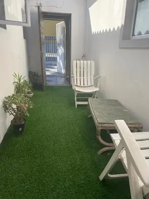 a patio with green grass and a table and chairs at Ludiz guest house in Parow