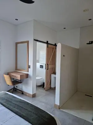 a bathroom with a sink and a desk and a mirror at Hermanus - Escape Wines - House on Wine & Protea farm in Lake Marina